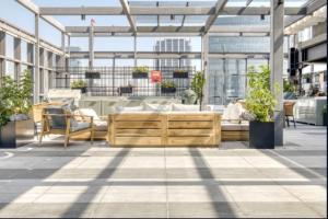 a patio with chairs and tables in a building at Pet-friendly Furnished 1BR Rental in Mexico City in Mexico City