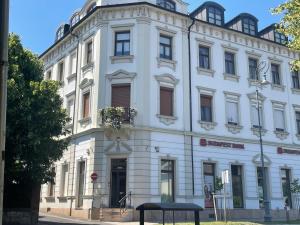 a white building with a sign in front of it at Studio Miamare in Keszthely