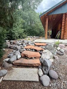 a stone pathway with rocks in front of a building at Evy's Family Ranch Cabin Secluded in Heber City +40 photos