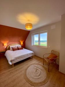 a bedroom with a bed and a window and a rug at L'horizon des vignes in Itterswiller +21 photos
