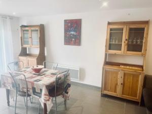 a dining room with a table and some chairs at Escapade au canal in Castelsarrasin
