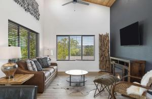 a living room with a couch and a tv at Modern Lake House in Kimberling City