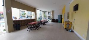 a hallway with tables and chairs in a building at Flat Quartier - Aldeia das Águas in Barra do Piraí
