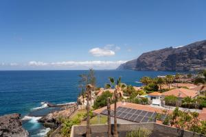 a view of the ocean from a house with solar panels at El Teide in Puerto de Santiago
