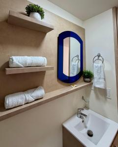 a bathroom with a sink and a mirror at Hotel Boutique Paralela Real. in Manizales