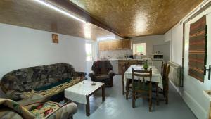 a living room with a couch and a table at Topole in Stapar
