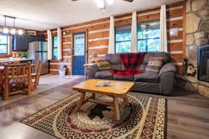 a living room with a couch and a table at Views, King & Sofa Bed, Hot Tub, Firepit And Deck in Sevierville