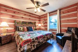 a bedroom with a bed and a ceiling fan at Views, King & Sofa Bed, Hot Tub, Firepit And Deck in Sevierville