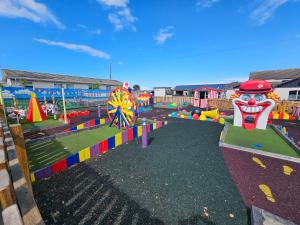 a playground with many different types of play equipment at Platinum Caravan with Decking & Garden in Abergele