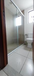 a glass shower in a bathroom with a toilet at Flat Quartier - Aldeia das Águas in Barra do Piraí +5 photos