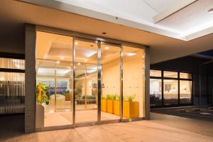 a lobby of a building with glass doors at Resort Hotel Mihagi in Hagi