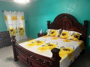 a bedroom with a wooden bed with flowers on it at Hotel Ruby in Agua Blanca Sur