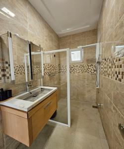 a bathroom with a sink and a shower at Modern and bright light room 