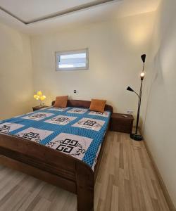 a bedroom with a bed with a quilt on it at Modern and bright light room 