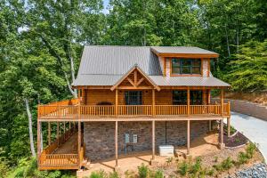 a log cabin with a wrap around deck at Whataview And Privacy Too by American Patriot Getaways in East Fork