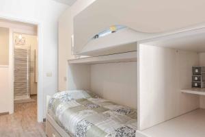 a white bedroom with a bed and a loft at Residenza l'Ulivo in Foiano della Chiana