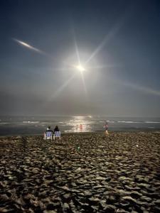 two people sitting in lawn chairs on a beach at Andalucia Cabo in Cabo Negro +2 photos