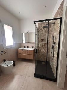 a bathroom with a shower and a toilet and a sink at Wellness House in Bagheria