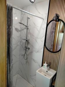 a white bathroom with a sink and a mirror at Chata pod lasem 