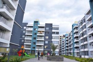 a group of people standing in front of buildings at Rieyo Homes 2 Bedrooms near Airport & SGR Train Station in Nairobi