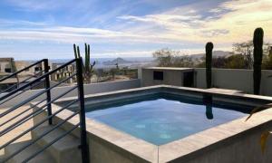 a swimming pool on the roof of a house at Residencial Sabina in Cabo San Lucas