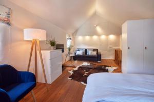 a bedroom with a bed and a couch in a room at Molls Ferienhäusel in Sankt Martin +9 photos