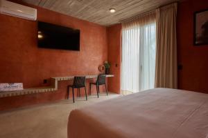 a bedroom with a bed and a table with two chairs at Casa Nadó in Brisas de Zicatela