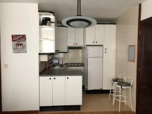 a kitchen with white cabinets and a refrigerator at centro de Medina de Pomar in Medina de Pomar +14 photos