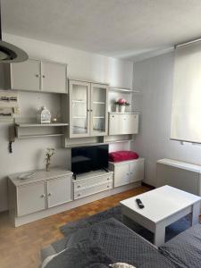a living room with white cabinets and a flat screen tv at centro de Medina de Pomar in Medina de Pomar +30 photos