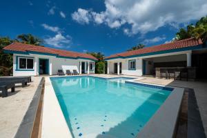 a swimming pool in front of a house at Space Freedom Connection in Sosúa