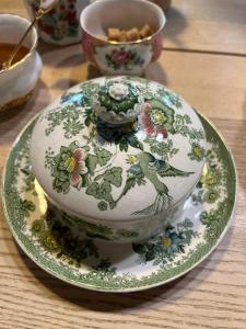 a vase sitting on a plate on a table at Maison 1838 
