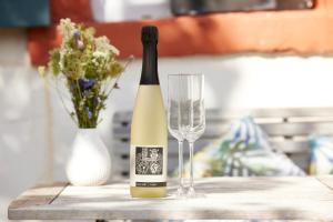 a bottle of wine and a glass on a table at Molls Ferienhäusel in Sankt Martin