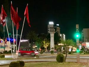 a car driving down a street at night with flags at Luxury apartment Fes centre ville - Family & Friendly in Fès