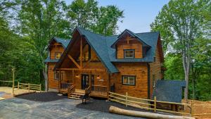 a cabin in the woods with a black roof at Swish Splash Lodge by American Patriot Getaways in Cartertown