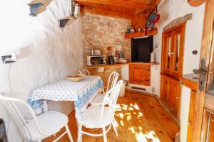 a kitchen with a table and chairs in a room at George's rooms in Stari Grad