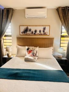a bedroom with a large bed with a white bedspread at Home For You in Gaborone