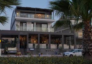 a building with a car parked in front of it at RUKA Hotel in Narlıdere