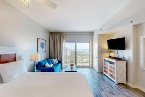 a bedroom with a bed and a tv and a couch at Luau I 7205 in Destin