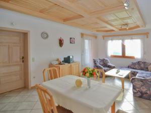 a living room with a table and a couch at Traudi in Waldkirchen +5 photos