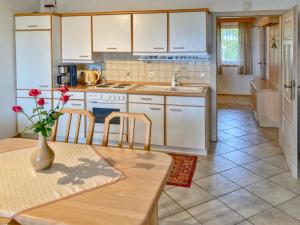 a kitchen with a table with a vase of flowers on it at Traudi in Waldkirchen