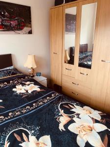 two beds in a room with a cabinet at The Glenton Getaway in Peterborough