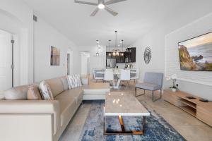 a living room with a couch and a table at Paradise Home 20 Mins to Disney with Pool and Waterpark on Property in Abbeyville