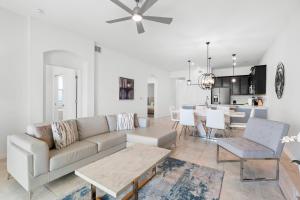 a living room and kitchen with a couch and a table at Paradise Home 20 Mins to Disney with Pool and Waterpark on Property in Abbeyville