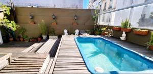 a small swimming pool in the backyard of a building at SanTelmo Casona Única 4Pisos Full Terraza Piscina Quincho Parrilla Ascensor 2Jacuzzis Sauna 7Dorm 6Baños in Buenos Aires