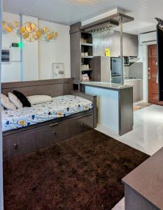 a kitchen with a large bed in a room at Cityloft Guesthouse in Tagbilaran City