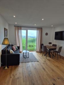 a living room with a couch and a table at Ferienwohnung NoEl in Dietmannsried