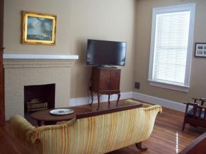 a living room with a couch and a fireplace at Large Historic Downtown Loft Front in Macon