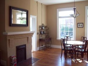 a living room with a table and a fireplace at Large Historic Downtown Loft Front in Macon