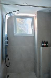 a bathroom with a shower with a window at Amazing Oceanfront 2br in Oropesa del Mar +31 photos