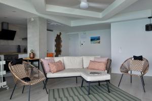 a living room with a couch and two chairs at Amazing Oceanfront 2br in Oropesa del Mar